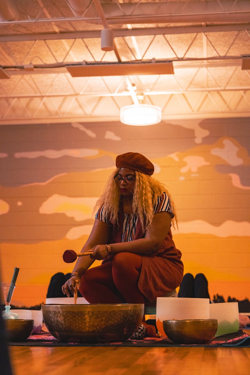 Sound healing practitioner playing singing bowls